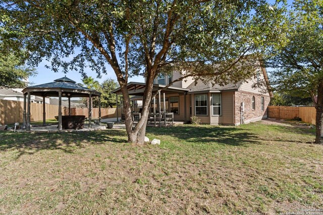 exterior space featuring a gazebo, a patio area, and a lawn