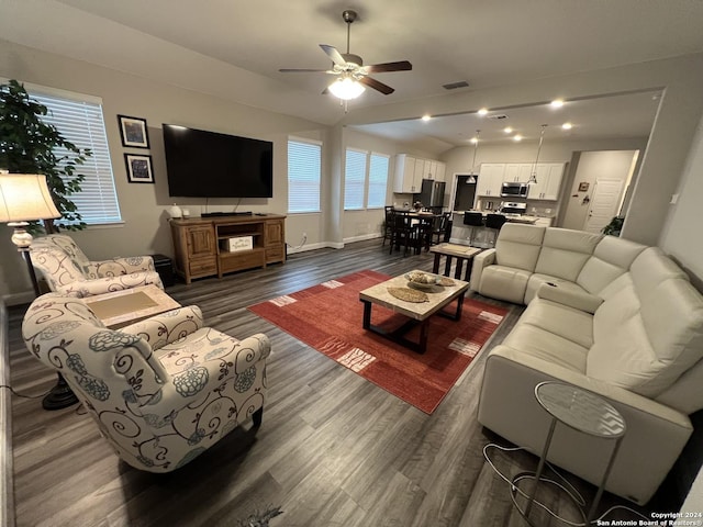 living room with dark hardwood / wood-style floors, ceiling fan, and lofted ceiling