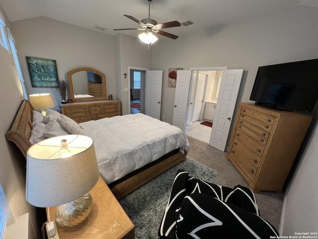 carpeted bedroom featuring connected bathroom, vaulted ceiling, and ceiling fan