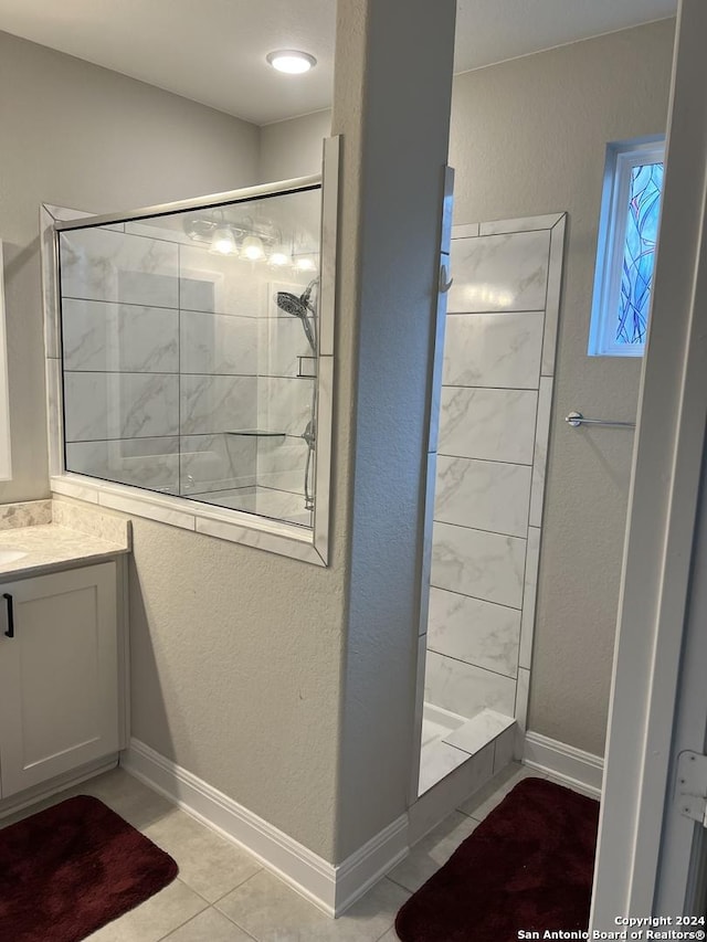 12142 Casparis, San Antonio, TX 78254 - bathroom with tiled shower, vanity, tile patterned flooring, and a textured wall