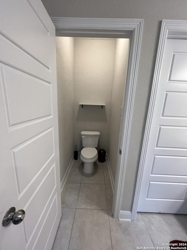 bathroom with tile patterned floors and toilet