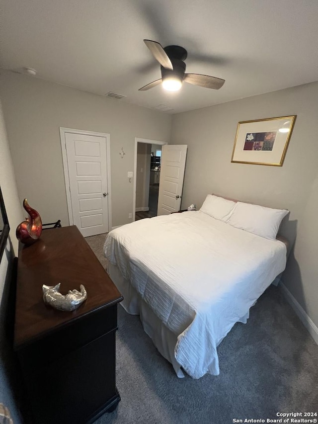 bedroom featuring ceiling fan and dark carpet