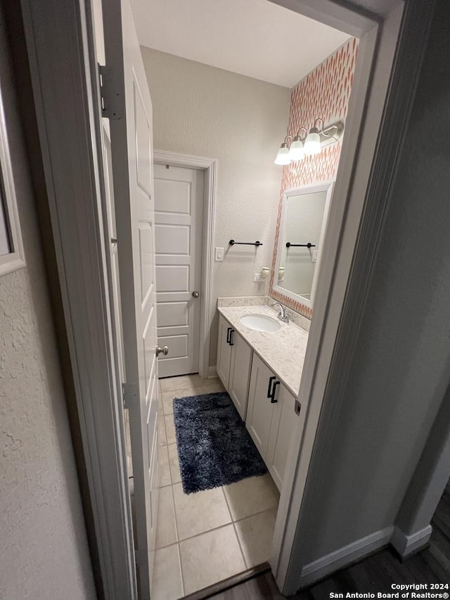 12142 Casparis, San Antonio, TX 78254 - bathroom with vanity, tile patterned floors, a textured wall, and baseboards