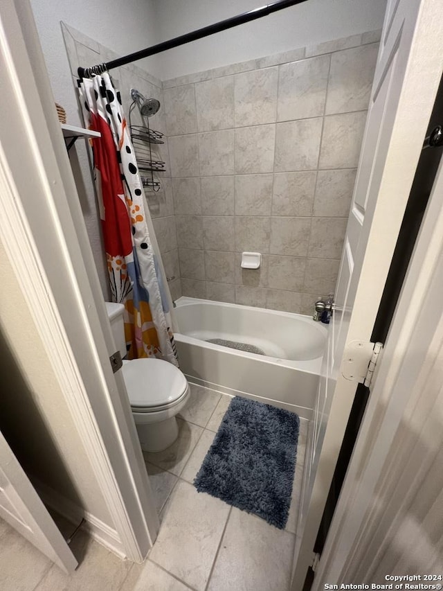 bathroom with tile patterned flooring, toilet, and shower / bathtub combination with curtain