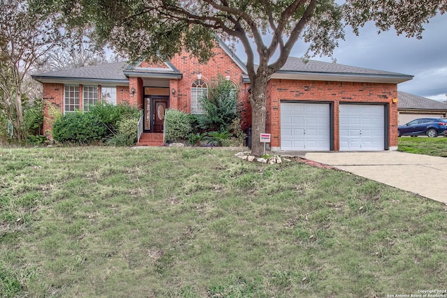 ranch-style home featuring a garage and a front yard