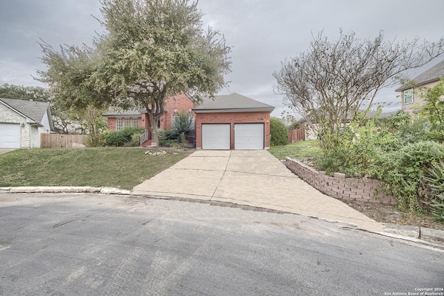 view of front of property featuring a front yard and a garage