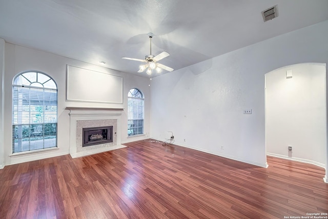 unfurnished living room with hardwood / wood-style flooring and ceiling fan