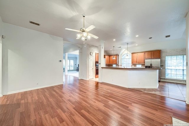 unfurnished living room featuring hardwood / wood-style floors and ceiling fan