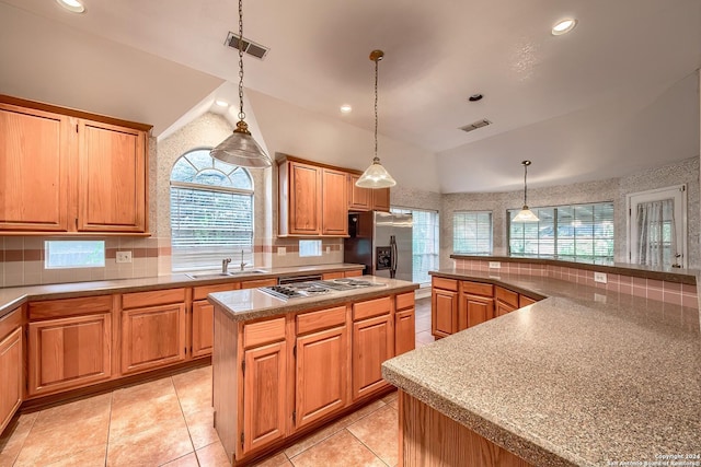 kitchen with a center island, a healthy amount of sunlight, sink, and appliances with stainless steel finishes