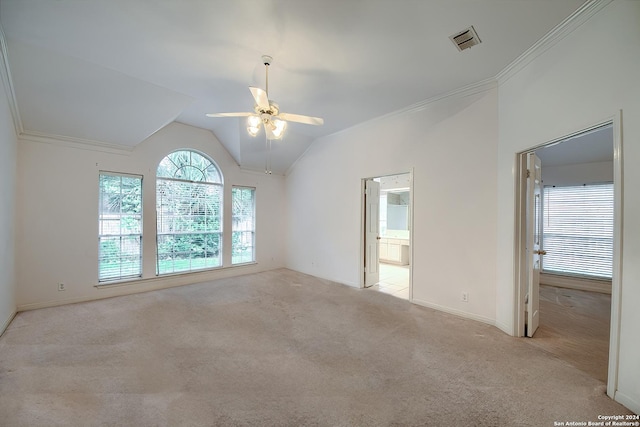 carpeted empty room with crown molding, ceiling fan, and vaulted ceiling