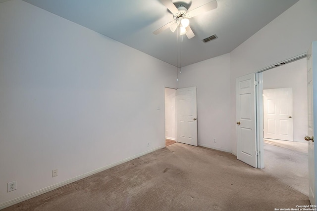 unfurnished bedroom featuring ceiling fan and light colored carpet