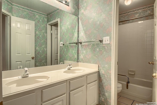 full bathroom featuring tile patterned floors, toilet, vanity, and tiled shower / bath