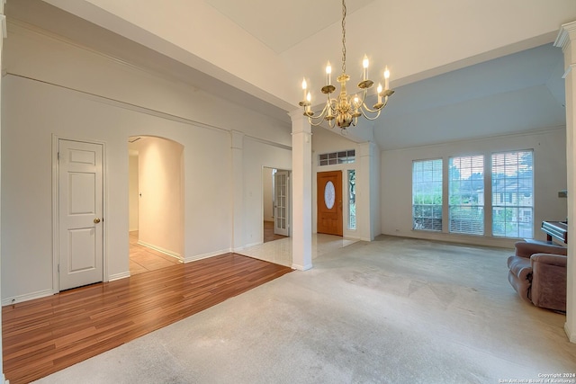 interior space featuring a chandelier, a high ceiling, and light wood-type flooring