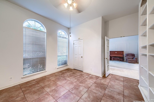 spare room featuring tile patterned flooring and ceiling fan