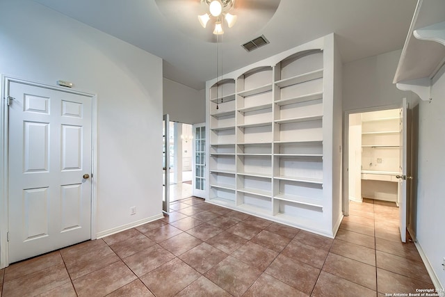 unfurnished bedroom featuring tile patterned floors and ceiling fan