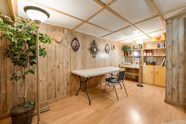 home office featuring wood walls and light wood-type flooring