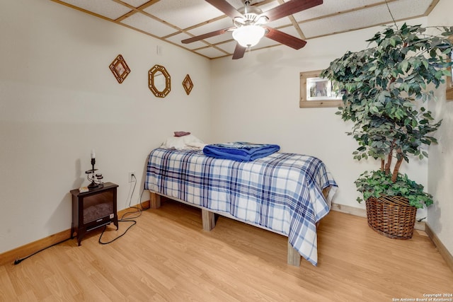 bedroom with ceiling fan and hardwood / wood-style floors