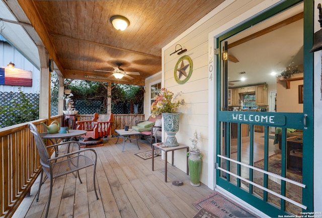 wooden deck featuring ceiling fan and a porch