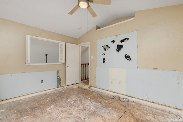 empty room featuring ceiling fan and vaulted ceiling