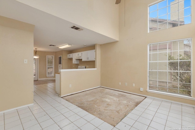 interior space with ceiling fan and light tile patterned floors