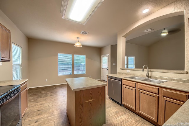 kitchen featuring dishwasher, a center island, sink, black electric range, and light hardwood / wood-style floors