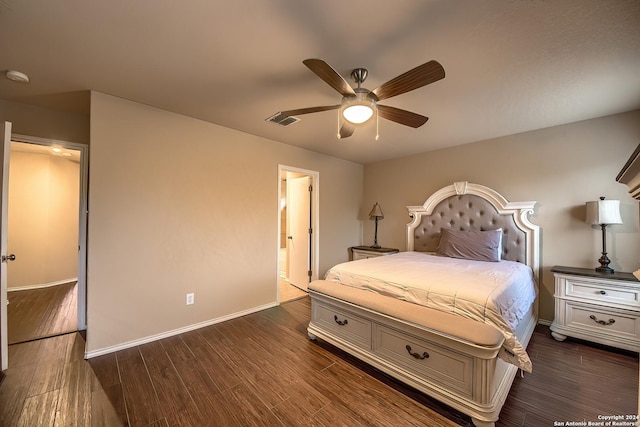 bedroom featuring ceiling fan, dark hardwood / wood-style flooring, and connected bathroom