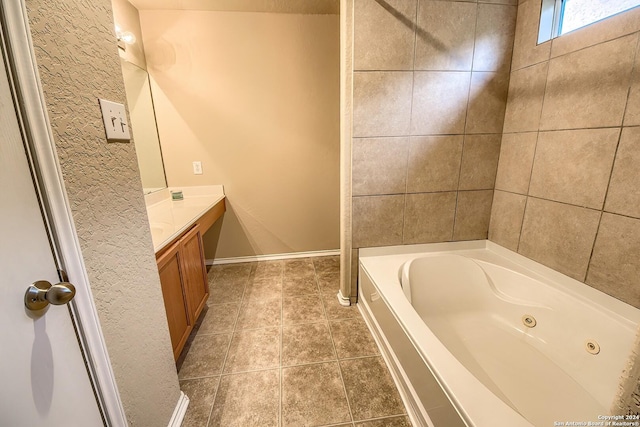 bathroom with tile patterned flooring, vanity, and a washtub