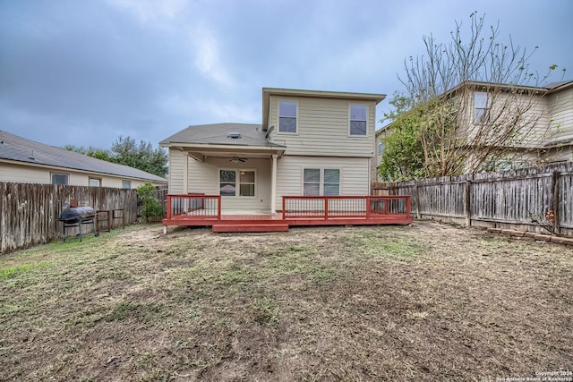 back of property with ceiling fan and a deck