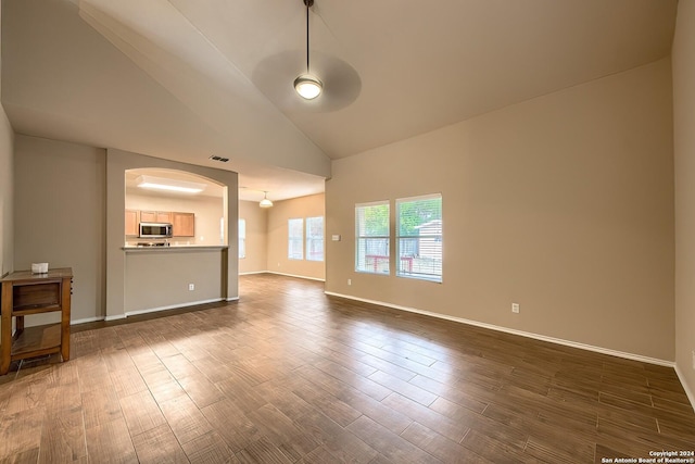 unfurnished living room with ceiling fan, dark hardwood / wood-style flooring, and high vaulted ceiling