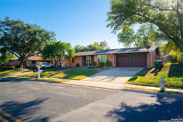 single story home with a garage and a front yard