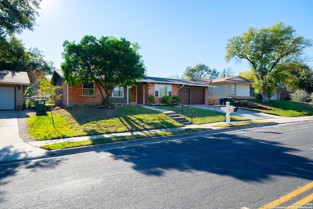 ranch-style house featuring a garage and a front lawn