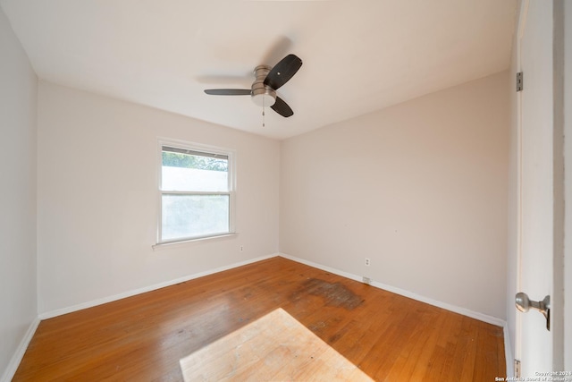 unfurnished room with ceiling fan and hardwood / wood-style floors