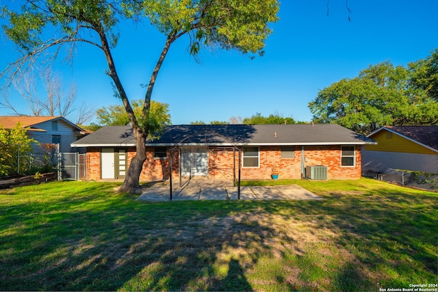 back of property featuring a lawn, a patio, and central AC unit