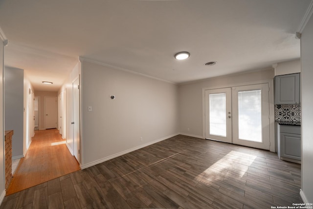 unfurnished room featuring french doors, dark hardwood / wood-style flooring, and ornamental molding