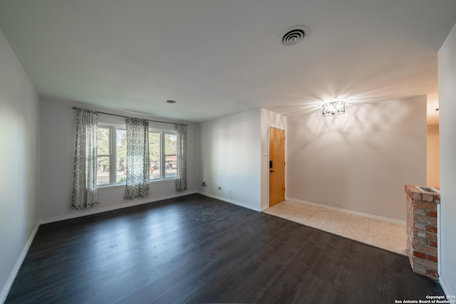 spare room with dark hardwood / wood-style floors