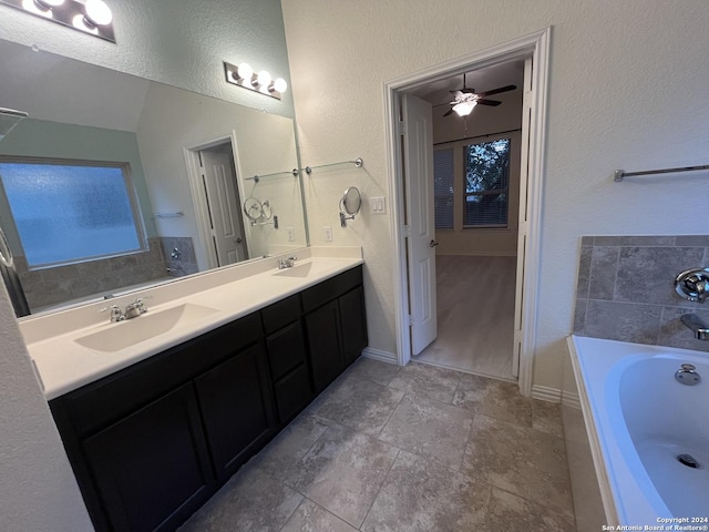 bathroom featuring a washtub, vanity, and ceiling fan