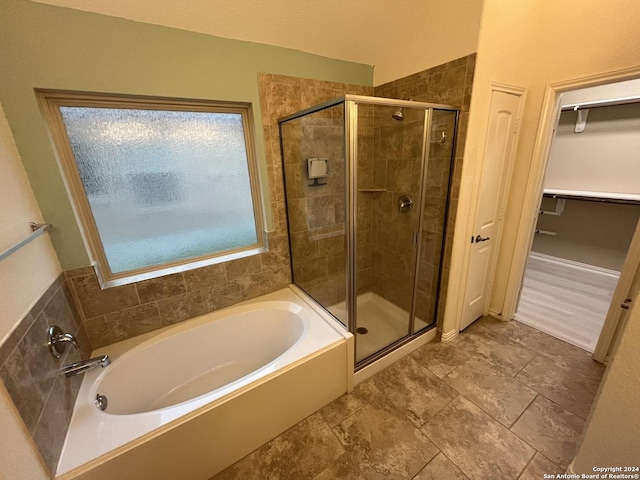 bathroom with separate shower and tub