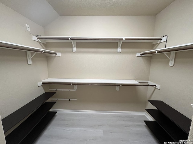 walk in closet featuring light hardwood / wood-style flooring