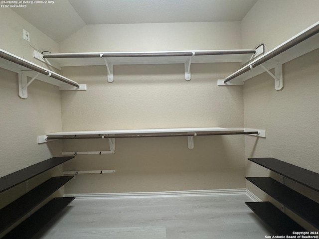 spacious closet with light hardwood / wood-style floors