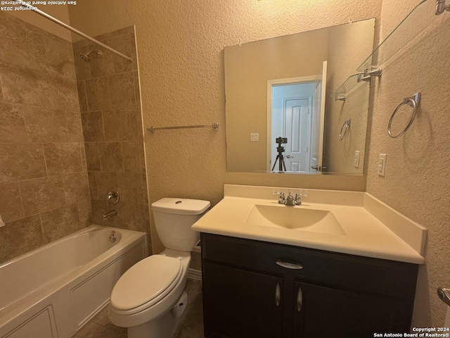 full bathroom with vanity, toilet, and tiled shower / bath