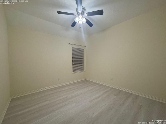 spare room with light hardwood / wood-style floors and ceiling fan