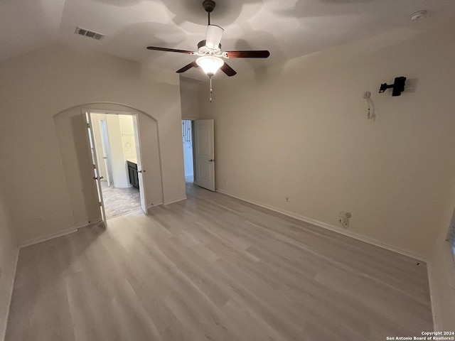 spare room with ceiling fan, light hardwood / wood-style floors, and vaulted ceiling