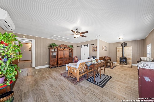 interior space featuring a wall mounted air conditioner, light wood-type flooring, and a wood stove