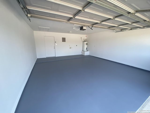 garage featuring electric panel, electric water heater, and a garage door opener