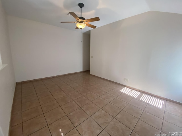 tiled spare room featuring ceiling fan and vaulted ceiling