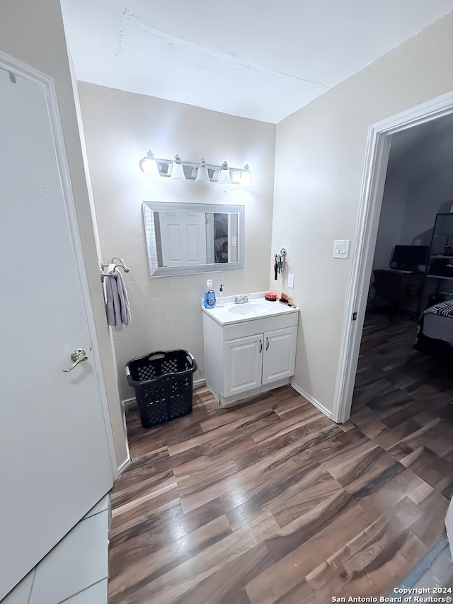 bathroom with hardwood / wood-style floors and vanity