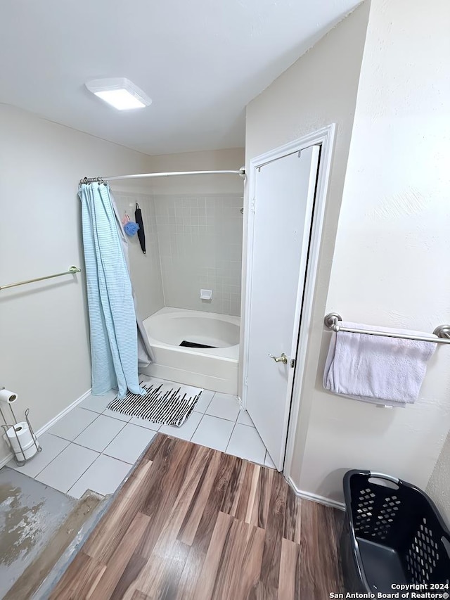 bathroom featuring shower / tub combo with curtain and wood-type flooring