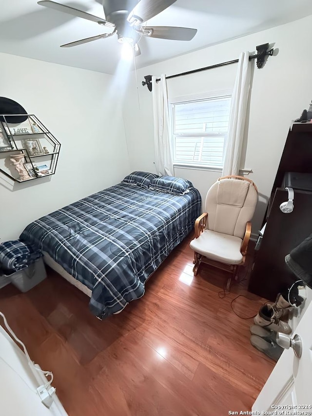 bedroom featuring ceiling fan and wood-type flooring