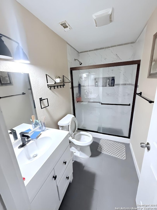 bathroom with toilet, a shower with door, vanity, and tile patterned flooring