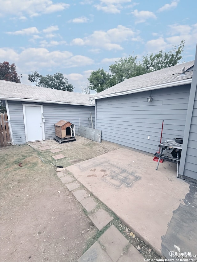 view of patio with an outbuilding